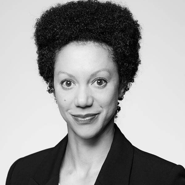 Professional black-and-white portrait of a smiling female attorney with curly hair, from our esteemed law firm based in Hamilton, Ontario.