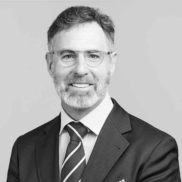 A professional monochrome headshot of a distinguished middle-aged legal practitioner donned with glasses, a suit and tie. He is proudly part of our Law Firm based in Hamilton, Ontario.