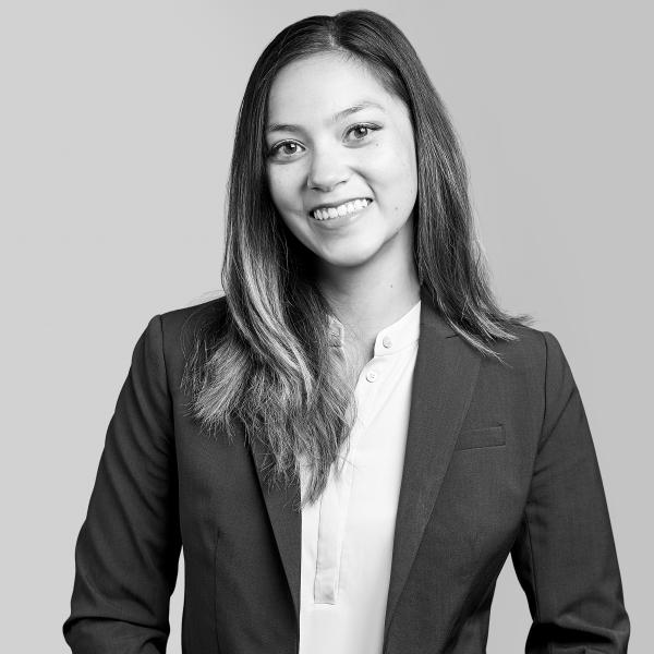 A professional monochrome photograph featuring a cheerful woman in business attire, proudly representing our Hamilton, Ontario-based law firm.